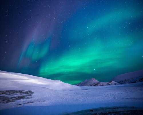 Northern lights aurora borealis over arctic landscape entertainment world